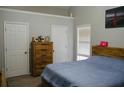 Bedroom with neutral paint and carpet, featuring two closets, one window, and space for storage above at 2350 Laurel Pointe Ln, Lawrenceville, GA 30043