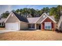 Charming single-story home with a two-car garage, brick accent and manicured lawn at 2350 Laurel Pointe Ln, Lawrenceville, GA 30043