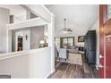 Open-concept living room with a fireplace, wood floors, and an abundance of natural light at 2350 Laurel Pointe Ln, Lawrenceville, GA 30043