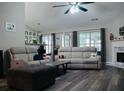 Inviting living room with vaulted ceiling, dark wood flooring, gray furnishings, and ample natural light at 2350 Laurel Pointe Ln, Lawrenceville, GA 30043