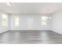 Bright living room with abundant natural light, featuring sleek gray flooring and modern finishes at 3021 Cambridge Mill St, Acworth, GA 30102