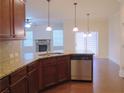 Open kitchen with stainless steel appliances, granite counters, and a view to the living room at 1205 Apple Blossom Dr, Cumming, GA 30041