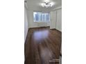 Bedroom features hardwood floors, window, and white door at 2479 Peachtree Ne Rd # 902, Atlanta, GA 30305