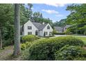Well-maintained white home surrounded by mature trees and greenery, offering a peaceful and private setting at 3648 Sope Creek Farm Se, Marietta, GA 30067