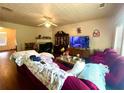 Living room featuring hardwood floors, a ceiling fan, fireplace, and a comfortable sofa at 1560 Park Grove Dr, Lawrenceville, GA 30046