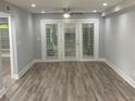 Bright living room featuring hardwood floors, fresh paint, and access to a private outdoor space at 3117 Colonial Way # G, Atlanta, GA 30341