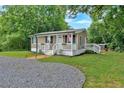 Lovely single-story home with neutral siding, white trim, and a welcoming front porch with flower boxes at 104 Gilreath Rd, Cartersville, GA 30121