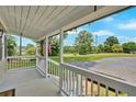 Inviting covered porch showcasing a glimpse of the home's exterior and surrounding landscape at 104 Gilreath Rd, Cartersville, GA 30121