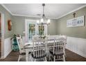 Inviting dining room with modern chandelier, French doors to back yard, and stylish wainscoting at 270 Meadow View Dr, Grayson, GA 30017