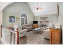 Bright and airy living room with vaulted ceiling, stone fireplace, and large window at 270 Meadow View Dr, Grayson, GA 30017