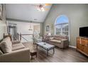 Spacious living room featuring vaulted ceiling, hardwood floors, and ample natural light from large windows at 270 Meadow View Dr, Grayson, GA 30017