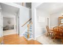 Bright foyer with hardwood floors, a staircase, and views into the dining and living areas at 263 Chandler Ridge Dr, Douglasville, GA 30134