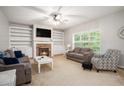 Comfortable living room featuring a stone fireplace, built-in shelving, and lots of natural light at 263 Chandler Ridge Dr, Douglasville, GA 30134