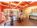Elegant dining room featuring a modern chandelier, coffered ceiling, and views into the living area at 366 Highbranch Cir, Lawrenceville, GA 30044