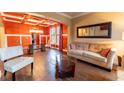 Cozy living room featuring an orange accent wall and comfortable beige sofa at 366 Highbranch Cir, Lawrenceville, GA 30044