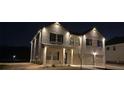 Beautifully illuminated exterior of a brick home at night, showcasing a welcoming and secure ambiance at 1612 Fuma Leaf Way, Mcdonough, GA 30253