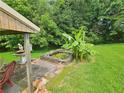 Backyard pond with foliage is a quiet, peaceful place to relax and enjoy nature at 2323 Cedar Terrace Rd, Lithia Springs, GA 30122