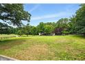Lush front yard boasts mature trees and a charming, fenced landscape at 891 Wooten Ct, Canton, GA 30114