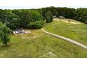 Aerial view of sprawling acreage featuring mature trees and fenced perimeter at 891 Wooten Ct, Canton, GA 30114