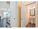 A powder room with a pedestal sink and access to a living space at 11686 Davenport Ln, Alpharetta, GA 30005