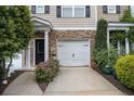 Charming townhome featuring stone accents, a two-car garage, and a well-maintained driveway at 3068 Lauren Parc Rd, Decatur, GA 30032