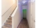 Hallway staircase with carpeted steps and white railings at 3068 Lauren Parc Rd, Decatur, GA 30032