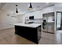 Modern kitchen featuring stainless steel appliances, a large island, and pendant lighting at 455 Saddle Bow Dr, Lawrenceville, GA 30046