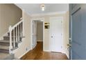 Inviting foyer with hardwood floors, staircase with white railing, and neutral wall colors creating a bright, welcoming space at 3866 Teresa Sw Ter, Lilburn, GA 30047