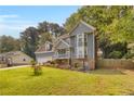 Well-maintained two-story home with beautiful landscaping, a long driveway, and complemented by mature trees in the backyard at 3866 Teresa Sw Ter, Lilburn, GA 30047