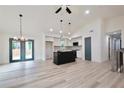 Open-concept kitchen and dining area featuring stainless appliances, center island, and stylish lighting fixtures at 5023 Rockborough Trl, Norcross, GA 30071