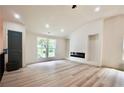 Bright living room with vaulted ceilings, modern fireplace, and new flooring, creating a warm and inviting space at 5023 Rockborough Trl, Norcross, GA 30071