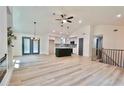 Open-concept living space featuring hardwood floors, pendant lights, and a kitchen island at 5023 Rockborough Trl, Norcross, GA 30071