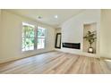 Bright living room featuring a modern fireplace and large windows at 5023 Rockborough Trl, Norcross, GA 30071
