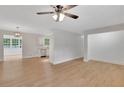 Bright and airy living room with laminate floors, neutral walls, and modern ceiling fan for comfortable living at 25 Carriage Ct, Stockbridge, GA 30281