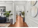 Inviting hallway with hardwood floors, elegant trim work, and a view into the open-concept living space at 3210 Ancoats St, Douglasville, GA 30135