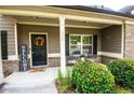 Cozy front porch with a welcome sign, flowers, and seating, creating a warm entry at 4560 Buckskin Way, Douglasville, GA 30135