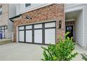 A well-designed garage door is framed by brick and landscaping, leading to a cozy front entrance at 94 Depot Landing Rd, Auburn, GA 30011