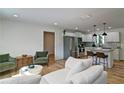 Bright, open-concept living room seamlessly connects to the kitchen with white cabinets and stainless steel appliances at 101 Stroud Se Dr, Mableton, GA 30126