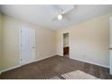 Neutral bedroom features carpet, white ceiling fan and a bathroom doorway at 120 Paces Lakes Pt, Dallas, GA 30157