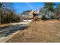 Traditional two-story home with a two-car garage, and a wood staircase leading to the front entrance at 120 Paces Lakes Pt, Dallas, GA 30157