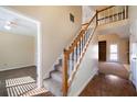 Bright, carpeted staircase leading to the second story with hardwood flooring at 120 Paces Lakes Pt, Dallas, GA 30157