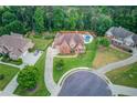 Aerial view of a home with a backyard pool, fence and lush greenery at 1283 Silver Trace Sw Dr, Lilburn, GA 30047