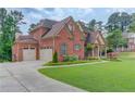 Charming brick home with a three-car garage, landscaped front yard at 1283 Silver Trace Sw Dr, Lilburn, GA 30047