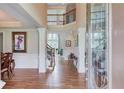 Elegant foyer with hardwood floors, staircase, and decorative columns at 1283 Silver Trace Sw Dr, Lilburn, GA 30047