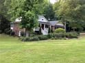 A well-maintained brick house with white trim and lush front yard landscaping at 19 Thimblemill Ct, Villa Rica, GA 30180