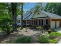 View of home's exterior with brick facade and two car garage at 19 Thimblemill Ct, Villa Rica, GA 30180