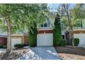 Townhouse exterior with an attached garage and mature landscaping at 2008 Hailston Dr, Duluth, GA 30097