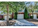 Townhouse exterior with an attached garage and mature landscaping at 2008 Hailston Dr, Duluth, GA 30097