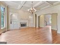 Spacious living room with coffered ceiling, fireplace, built-in shelving, and hardwood flooring at 6205 Arnall Nw Ct, Acworth, GA 30101