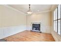 Cozy living room featuring a fireplace, large window with bright light, and hardwood flooring at 6205 Arnall Nw Ct, Acworth, GA 30101